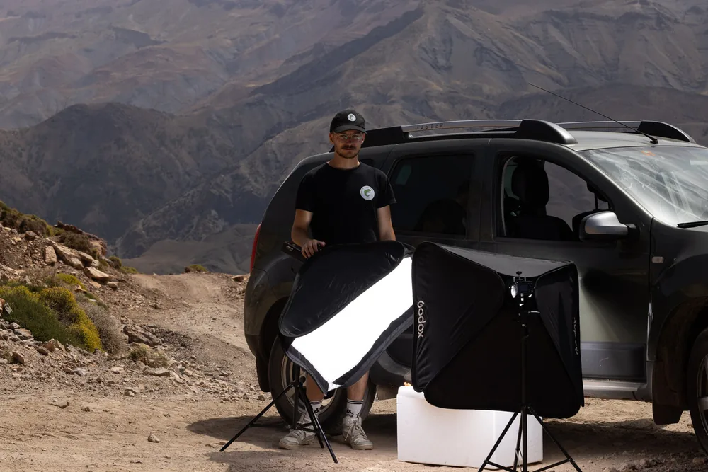 White-background studio set up beside the vehicle in the mountains